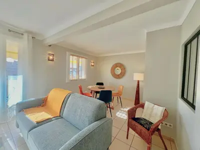 a living room with a blue couch and a table at Savannah appartement proche Carlton, by Welcome to Cannes in Cannes