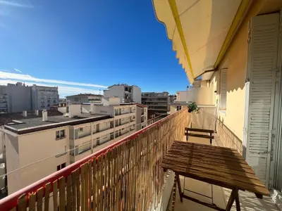 a balcony with a bench and a view of the city at Savannah appartement proche Carlton, by Welcome to Cannes in Cannes