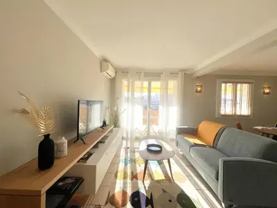 a living room with a couch and a table at Savannah appartement proche Carlton, by Welcome to Cannes in Cannes