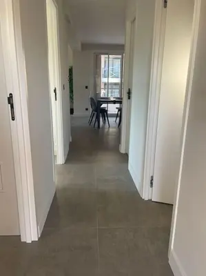 a hallway with a table and chairs in a room at Appartement MARTINEZ 5 couchages in Cannes