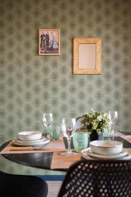 a table with plates and wine glasses on it at Jessicannes - COOPER - 3 chambres - Central, spacieux, terrasse in Cannes