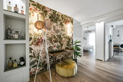 a living room with a wall with a floral wallpaper at Jessicannes - COOPER - 3 chambres - Central, spacieux, terrasse in Cannes
