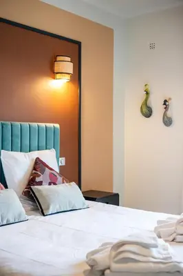 a bedroom with a white bed with a blue headboard at Jessicannes - COOPER - 3 chambres - Central, spacieux, terrasse in Cannes