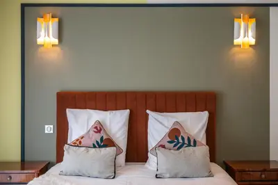 a bedroom with a bed with two pillows at Jessicannes - COOPER - 3 chambres - Central, spacieux, terrasse in Cannes