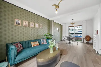 a living room with a blue couch and a table at Jessicannes - COOPER - 3 chambres - Central, spacieux, terrasse in Cannes