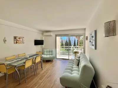 a living room with a couch and a table at Mimosas by Welcome to Cannes in Cannes