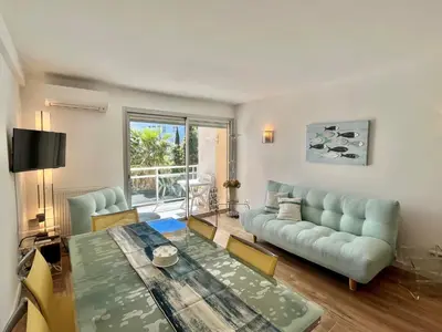a living room with a couch and a table at Mimosas by Welcome to Cannes in Cannes