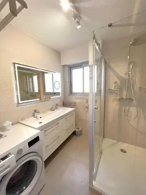 a bathroom with a washing machine and a shower at Mimosas by Welcome to Cannes in Cannes