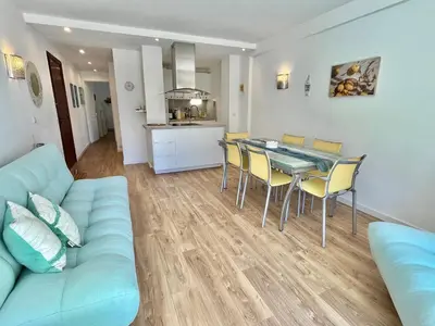 a living room with a couch and a table and chairs at Mimosas by Welcome to Cannes in Cannes