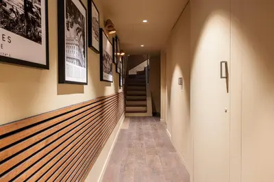 a hallway of a house with pictures on the walls at WABISABI SUITES - MÉRO in Cannes