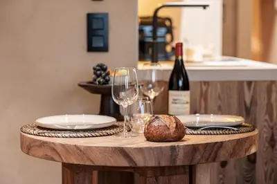 a table with wine glasses and a bread on it at WABISABI SUITES - MÉRO in Cannes