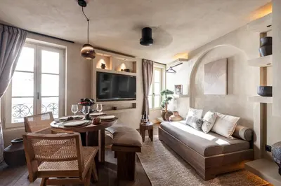 a living room with a couch and a table at WABISABI SUITES - MÉRO in Cannes