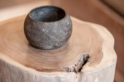 a cup sitting on top of a wooden table at WABISABI SUITES - MÉRO in Cannes