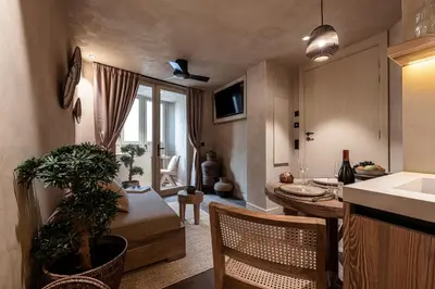 a kitchen and living room with a table and a sink at WABISABI SUITES - MÉRO in Cannes
