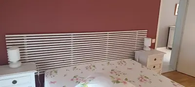 a bedroom with a bed with a white headboard at Ciel Bleu de Cannes - Appartement Vue Azur avec Piscines et Jardin in Cannes