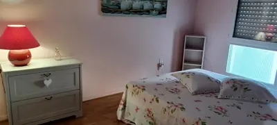 a bedroom with a bed and a lamp on a nightstand at Ciel Bleu de Cannes - Appartement Vue Azur avec Piscines et Jardin in Cannes