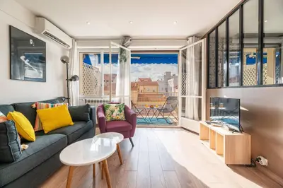 a living room with a couch and a large window at 3 VIDAL - Splendide appartement 4 couchage hyper centre de Cannes in Cannes