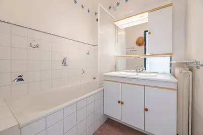 a bathroom with a tub and a sink and a bath tubermottermott at 3 VIDAL - Splendide appartement 4 couchage hyper centre de Cannes in Cannes