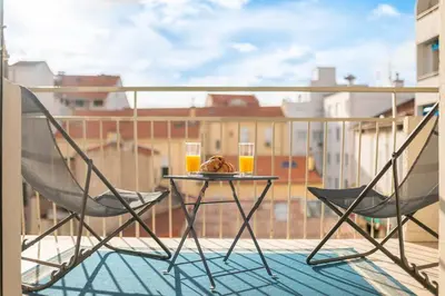 a table and two chairs on a balcony with drinks at 3 VIDAL - Splendide appartement 4 couchage hyper centre de Cannes in Cannes