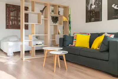 a living room with a couch and two tables at 3 VIDAL - Splendide appartement 4 couchage hyper centre de Cannes in Cannes