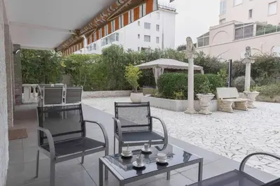 a patio with two chairs and a table at Jardin d'Azur – Terrace, Calm & Croisette in Cannes