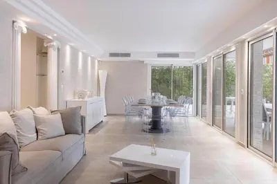 a living room with a couch and a table at Jardin d'Azur – Terrace, Calm & Croisette in Cannes