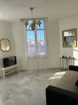 a living room with a large window and a television at Studio 6minutes Croisette cannes in Cannes
