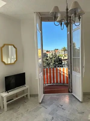 a living room with a door open to a balcony at Studio 6minutes Croisette cannes in Cannes
