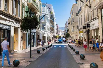 a city street with people walking down the street at Studio 6minutes Croisette cannes in Cannes