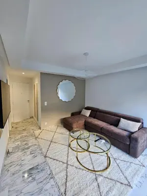 a living room with a couch and a table at Charmant studio centre de Cannes in Cannes