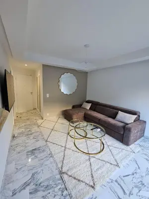 a living room with a couch and a table at Charmant studio centre de Cannes in Cannes