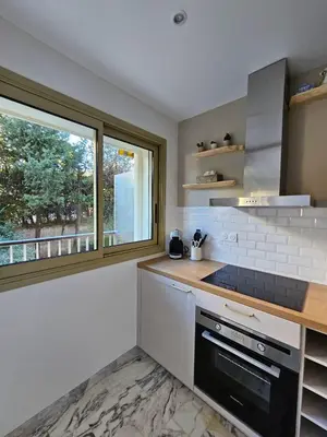 a kitchen with a stove and a window at Charmant studio centre de Cannes in Cannes