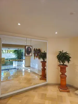 a lobby with two potted plants on the wall at Charmant studio centre de Cannes in Cannes