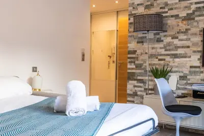 a bedroom with a bed and a desk and a chair at RARE ! Studio with terrace 5min walk to the Palais in Cannes