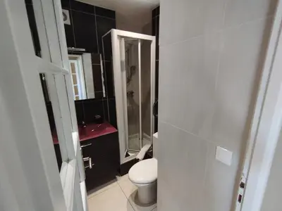 a bathroom with a toilet and a glass shower at Cannes Palm Beach Parking, clim, wifi plage 2' à pieds in Cannes