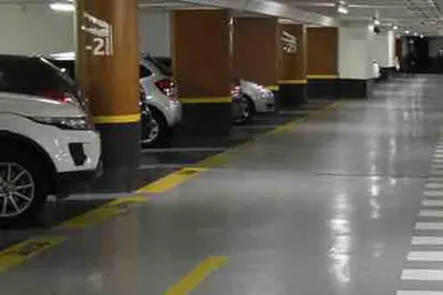a parking lot with cars parked in a parking garage at Mythique Miramar Cannes Croisette Terrasse Clim Parking Wifi in Cannes
