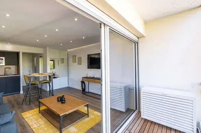 a living room with a couch and a table at 8 MERLE - Beau studio au centre de Cannes avec balcon ! in Cannes