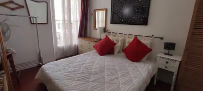 a bedroom with a bed with red pillows on it at Large 2-Room Apartment Cannes - Wifi, Air Conditioning in Cannes