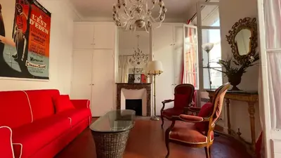 a living room with a red couch and chairs at Large 2-Room Apartment Cannes - Wifi, Air Conditioning in Cannes