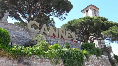 a sign on a wall with trees and a tower at Large 2-Room Apartment Cannes - Wifi, Air Conditioning in Cannes
