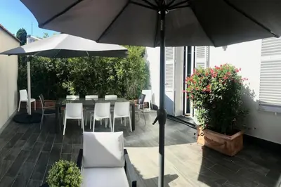 a patio with a table and chairs and an umbrella at Marvellous 5 bed Cannes Centre in Cannes