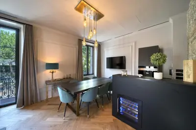 a dining room with a table and chairs and a fireplace at Marvellous 5 bed Cannes Centre in Cannes