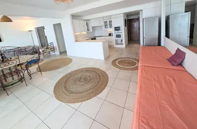 a large living room with a couch and a kitchen at Ref BELLAMARE in Cannes