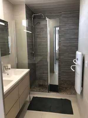 a bathroom with a shower and a sink and a shower at Magnifique studio au pied des plages in Cannes