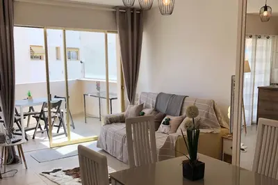 a living room with a couch and a table at Magnifique studio au pied des plages in Cannes