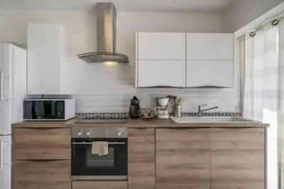 a kitchen with a stove and a microwave at Magnifique studio au pied des plages in Cannes