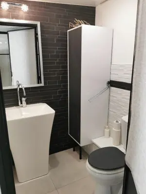 a bathroom with a white toilet and a sink at Magnifique studio au pied des plages in Cannes