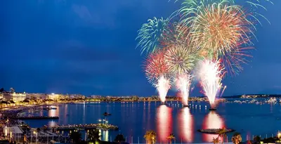 a firework display over a body of water at Comfortable studio near the beaches in Cannes