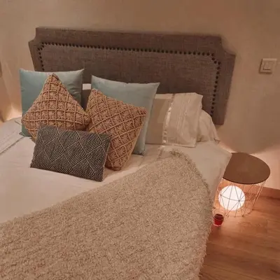 a bed with a bunch of pillows on it at Studio Latour Maubourg in Cannes