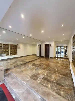 a large empty room with a large marble floor at Studio Latour Maubourg in Cannes